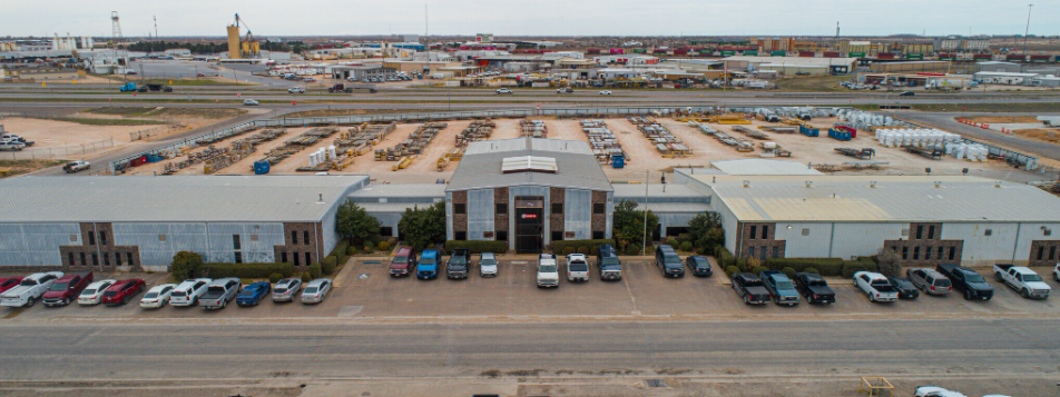 Aerial view of an industrial building with attached office and rail-served yard at 2222 Commerce Drive, Midland, Texas