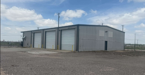 Shop building with three overhead doors at the Crane Ave property