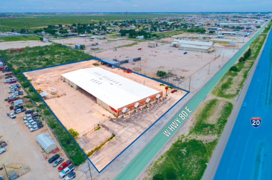 Aerial view of a 33,000 square foot industrial building at 13500 W Hwy 80 E, Odessa, Texas, adjacent to Interstate 20