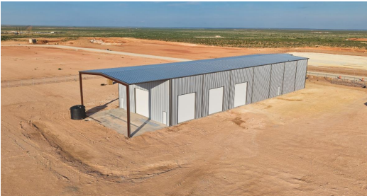 Steel industrial building under a wide West Texas sky